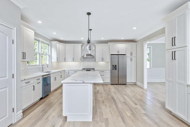 223 Townline Rd, Commack, NY 11725 - kitchen featuring appliances with stainless steel finishes, a sink, crown molding, decorative backsplash, and white cabinets