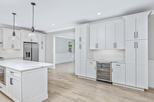 223 Townline Rd, Commack, NY 11725 - kitchen with appliances with stainless steel finishes, wine cooler, white cabinetry, crown molding, and recessed lighting
