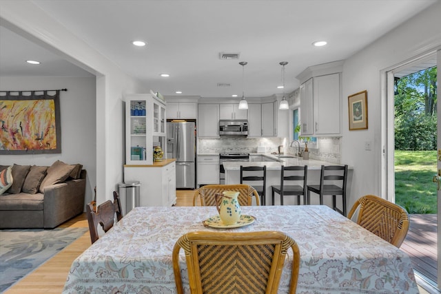10 Bay Dr W, Huntington Bay, NY 11743 - dining area with light wood-style flooring and recessed lighting