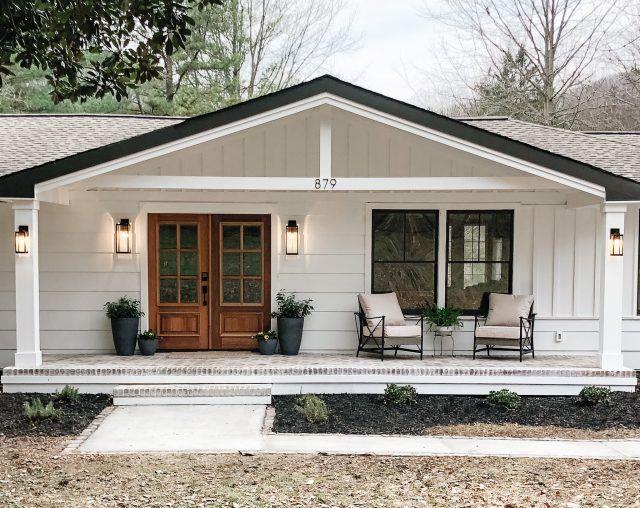 10 Bay Dr W, Huntington Bay, NY 11743 - doorway to property with board and batten siding, covered porch, and roof with shingles