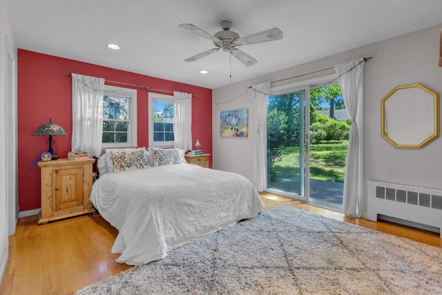 10 Bay Dr W, Huntington Bay, NY 11743 - bedroom featuring radiator heating unit, access to outside, wood finished floors, recessed lighting, and a ceiling fan