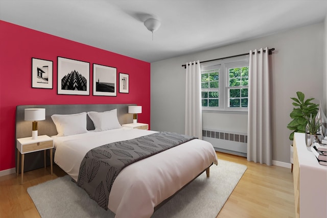 10 Bay Dr W, Huntington Bay, NY 11743 - bedroom featuring radiator, wood finished floors, and baseboards