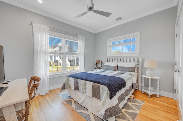bedroom featuring ornamental molding, baseboards, light wood finished floors, ceiling fan, and recessed lighting