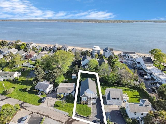 aerial view of residential area featuring a nearby body of water and property boundaries highlighted