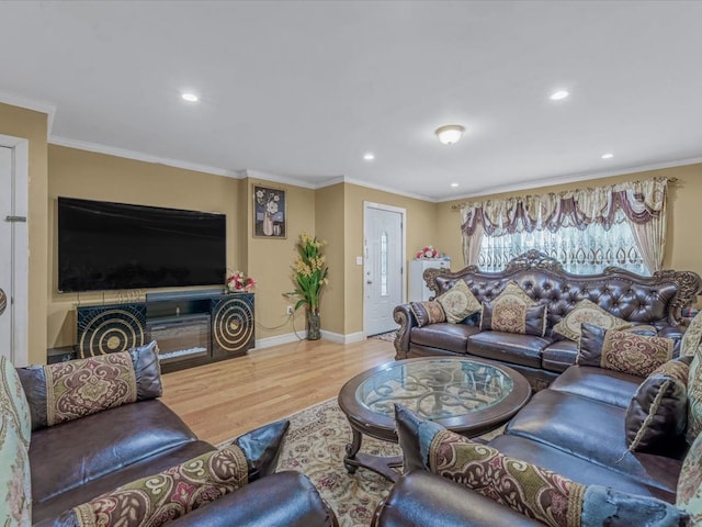 living room with wood finished floors, recessed lighting, baseboards, and crown molding