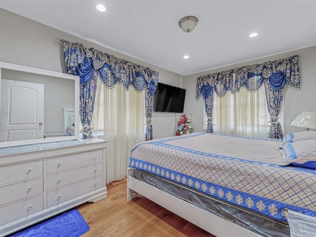 bedroom with light wood-style floors and recessed lighting