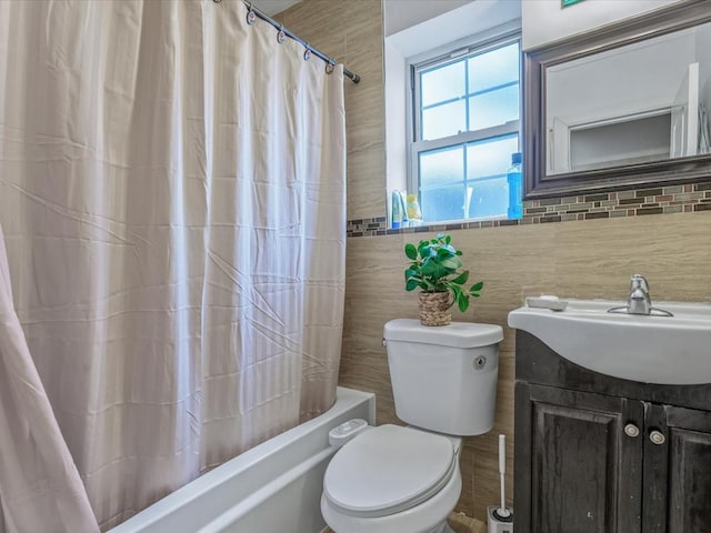 bathroom with vanity, shower / bath combination with curtain, and toilet