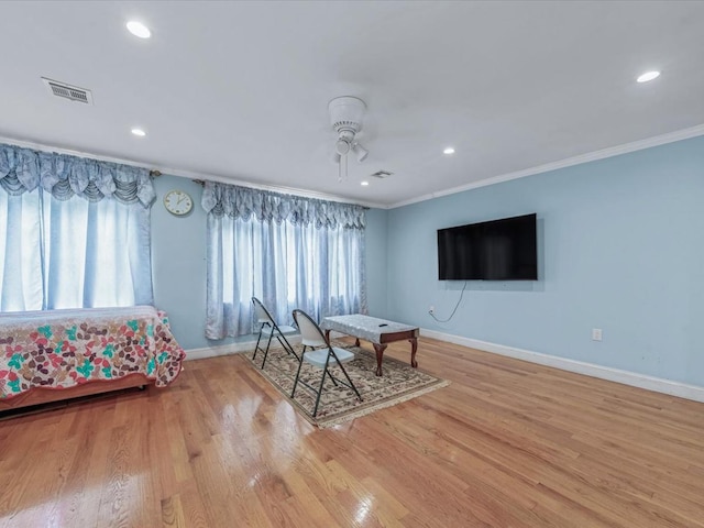 bedroom featuring baseboards, crown molding, light wood finished floors, and recessed lighting