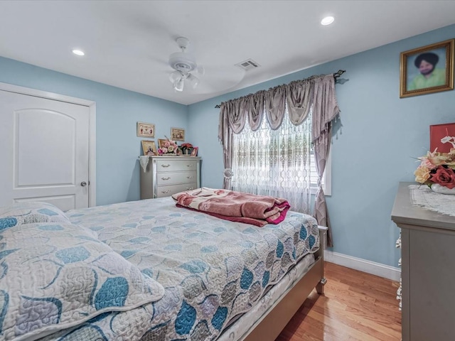 bedroom featuring light wood-type flooring, recessed lighting, a ceiling fan, and baseboards