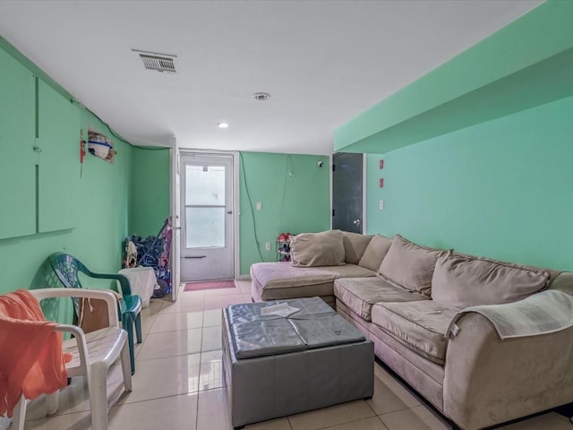 living room with light tile patterned floors and recessed lighting