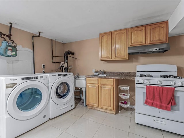 washroom featuring washing machine and dryer and light tile patterned floors