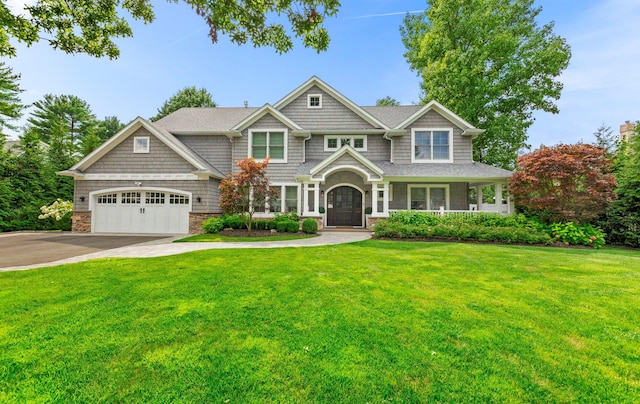 15 Wagamon Dr, Woodbury, NY 11797 - view of front of property featuring concrete driveway, a garage, a front lawn, and stone siding