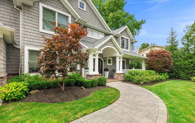15 Wagamon Dr, Woodbury, NY 11797 - craftsman inspired home featuring covered porch, a front yard, and stone siding