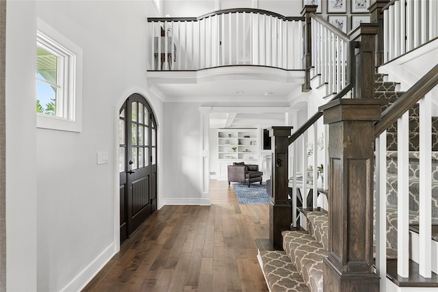15 Wagamon Dr, Woodbury, NY 11797 - entryway with stairway, baseboards, a high ceiling, dark wood-style floors, and crown molding