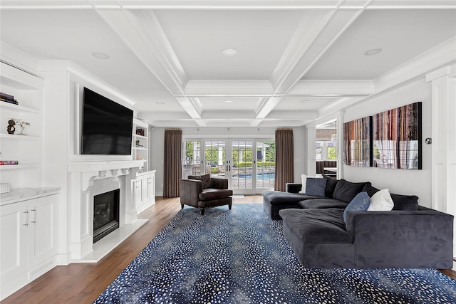 15 Wagamon Dr, Woodbury, NY 11797 - living room featuring a high end fireplace, wood finished floors, beamed ceiling, coffered ceiling, and crown molding