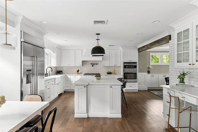 15 Wagamon Dr, Woodbury, NY 11797 - kitchen featuring appliances with stainless steel finishes, decorative backsplash, white cabinetry, light countertops, and recessed lighting