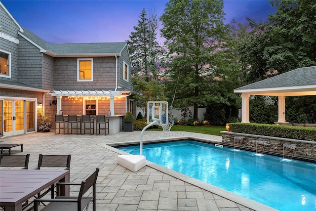 15 Wagamon Dr, Woodbury, NY 11797 - pool at dusk featuring french doors, a patio, a pergola, and a gazebo