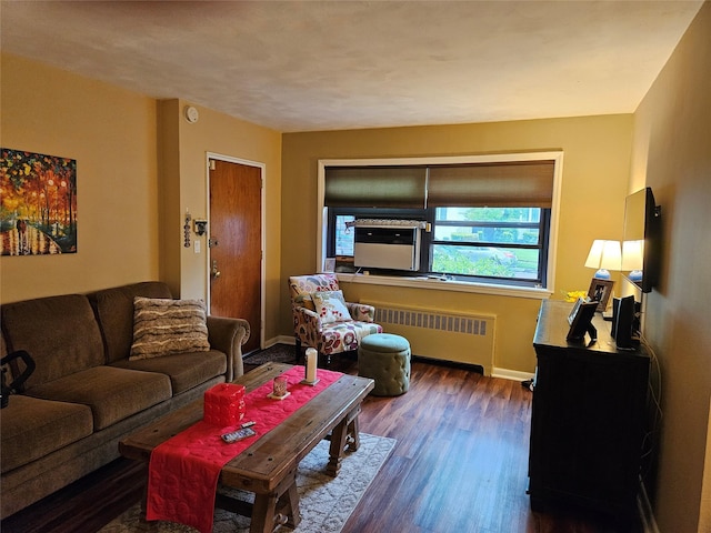 living area featuring radiator, dark wood-style flooring, and baseboards