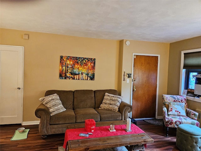 living area featuring dark wood-type flooring and baseboards