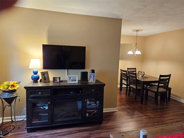 living room featuring baseboards and dark wood finished floors