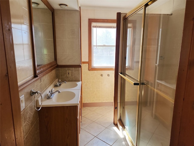 full bathroom featuring a shower stall, tile walls, tile patterned floors, and double vanity