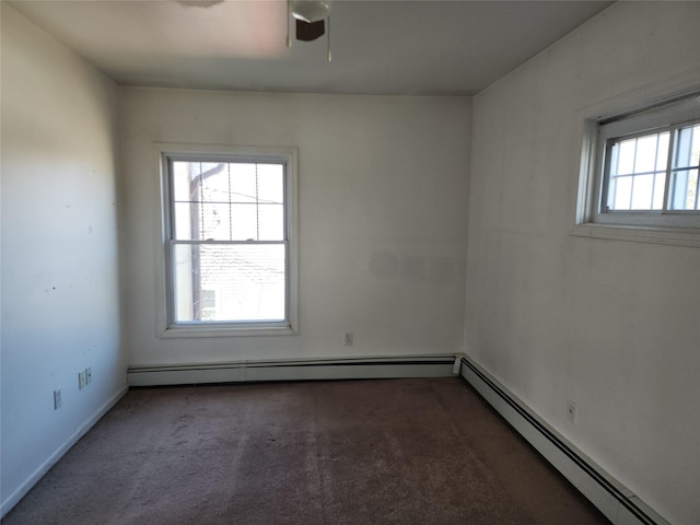 spare room with a baseboard heating unit, carpet, ceiling fan, and baseboards