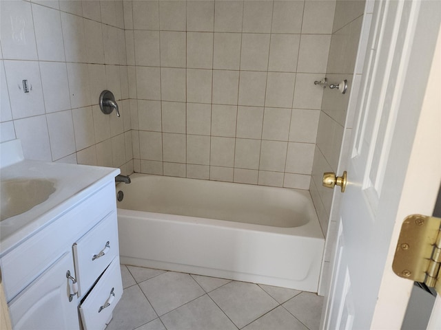 full bathroom with tile patterned floors, vanity, tile walls, and shower / washtub combination