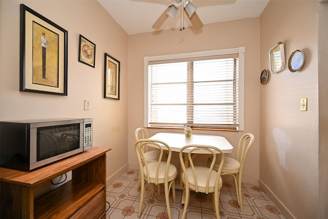 dining room with a ceiling fan and baseboards