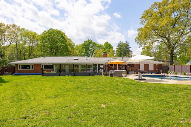 back of house with a patio area, a hot tub, and a chimney
