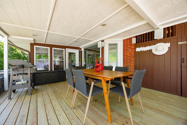 sunroom / solarium featuring outdoor dining space