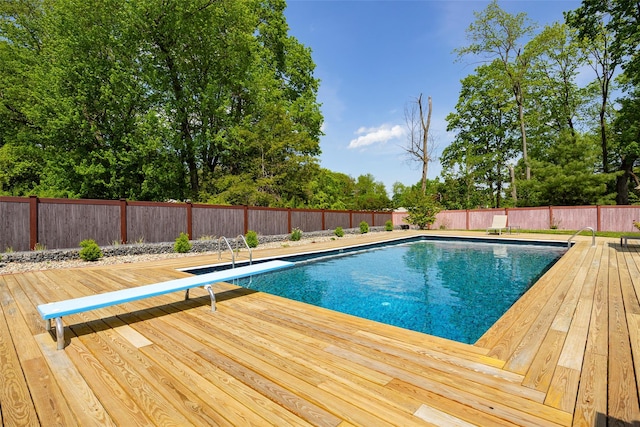 view of pool featuring a wooden deck and a fenced backyard
