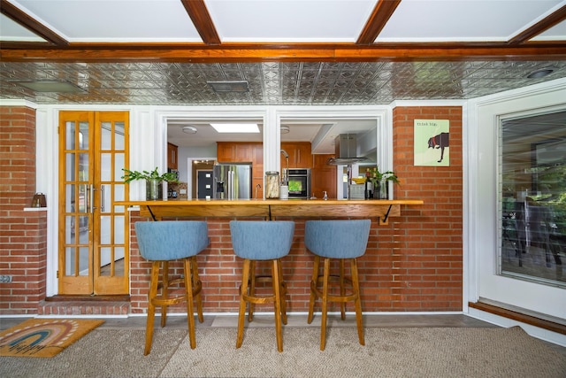 bar featuring stainless steel fridge, wall oven, island exhaust hood, and carpet floors