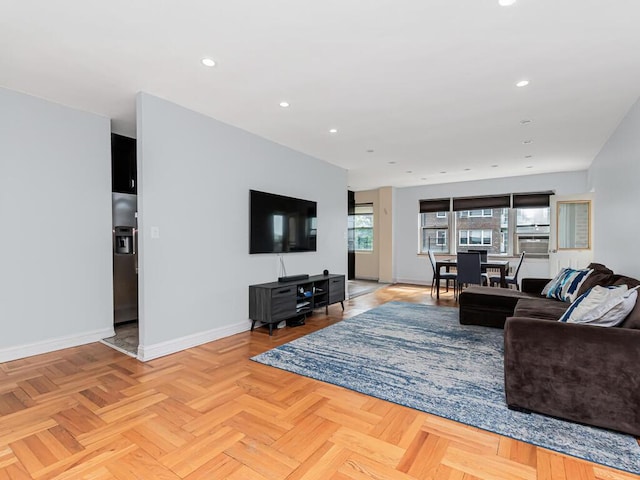 living area featuring baseboards and recessed lighting