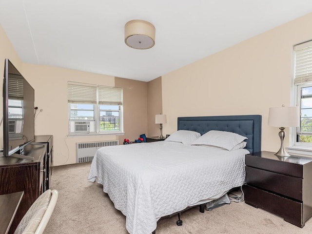 bedroom with radiator heating unit and carpet floors