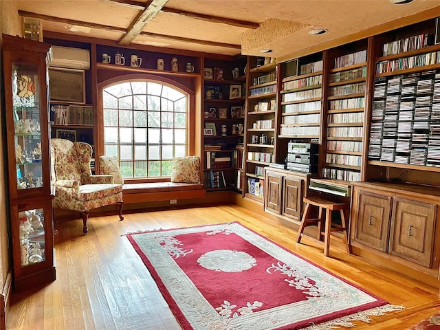 59 Sunset Rd, Bay Shore, NY 11706 - office area with wood finished floors, an AC wall unit, and built in shelves