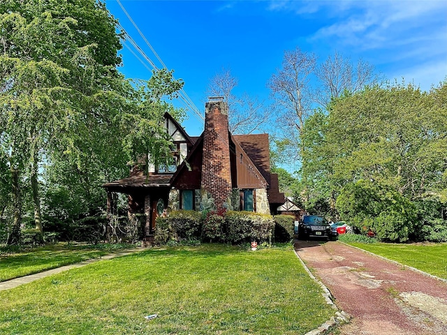 59 Sunset Rd, Bay Shore, NY 11706 - view of front facade featuring driveway, a chimney, and a front yard