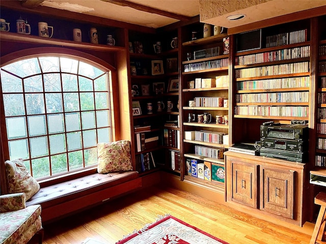 59 Sunset Rd, Bay Shore, NY 11706 - living area with light wood-style floors and wall of books