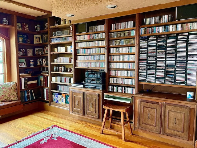 59 Sunset Rd, Bay Shore, NY 11706 - living area featuring wood finished floors and wall of books