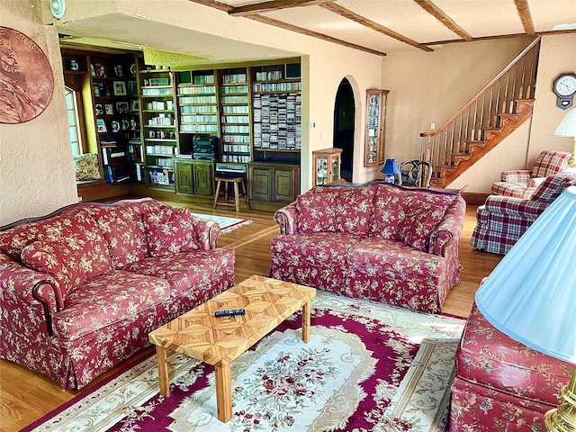 59 Sunset Rd, Bay Shore, NY 11706 - living room featuring a textured wall, wood finished floors, stairway, and arched walkways