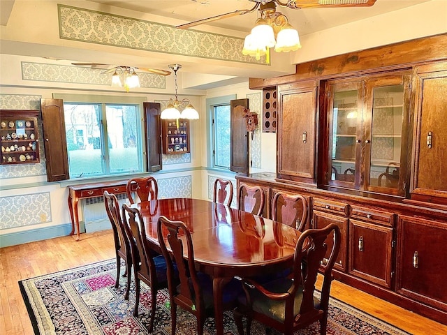 59 Sunset Rd, Bay Shore, NY 11706 - dining room featuring light wood finished floors, a chandelier, and a ceiling fan