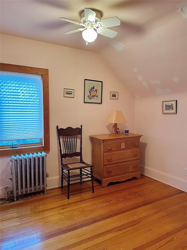 59 Sunset Rd, Bay Shore, NY 11706 - sitting room with radiator heating unit, ceiling fan, light wood-type flooring, vaulted ceiling, and baseboards