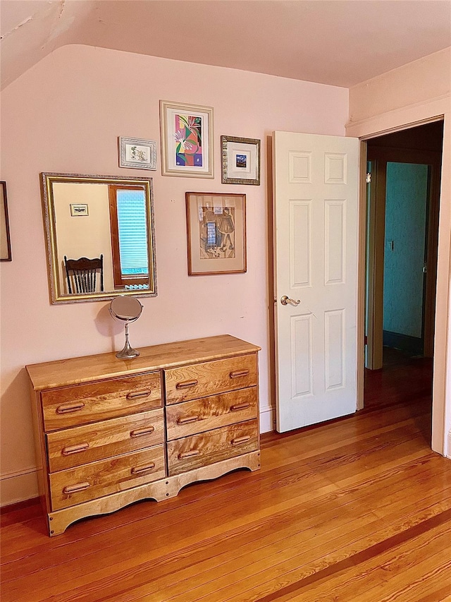 59 Sunset Rd, Bay Shore, NY 11706 - hallway with light wood-type flooring, vaulted ceiling, and baseboards