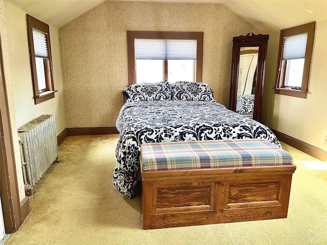 59 Sunset Rd, Bay Shore, NY 11706 - bedroom featuring radiator, light colored carpet, lofted ceiling, multiple windows, and baseboards