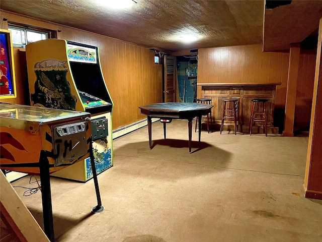 59 Sunset Rd, Bay Shore, NY 11706 - playroom featuring a bar, wooden walls, concrete flooring, and a baseboard heating unit