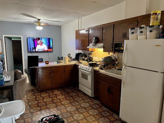 60-85 55th St, Maspeth, NY 11378 - kitchen with white appliances, light countertops, a ceiling fan, a paneled ceiling, and a peninsula
