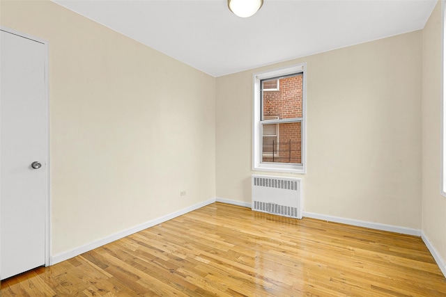 67-30 Clyde St Unit 6W, Forest Hills, NY 11375 - empty room featuring radiator heating unit, light wood-type flooring, and baseboards