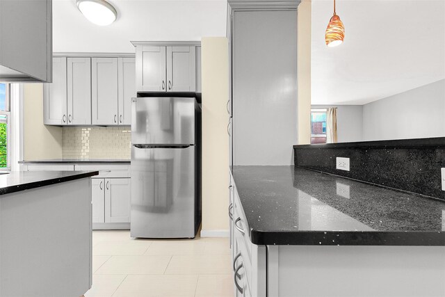 67-30 Clyde St Unit 6W, Forest Hills, NY 11375 - kitchen with freestanding refrigerator, tasteful backsplash, dark stone counters, and gray cabinetry