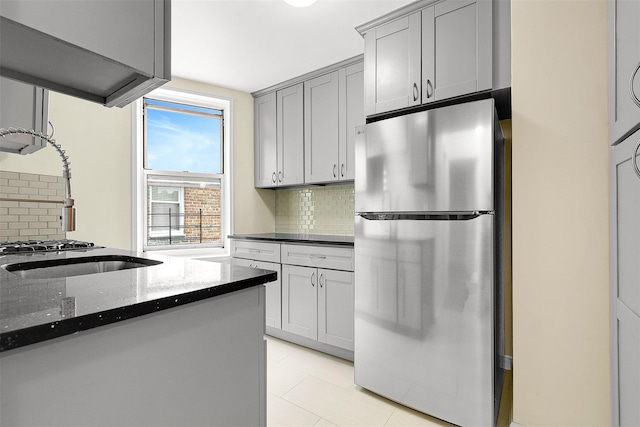 67-30 Clyde St Unit 6W, Forest Hills, NY 11375 - kitchen with freestanding refrigerator, dark stone countertops, tasteful backsplash, and gray cabinetry