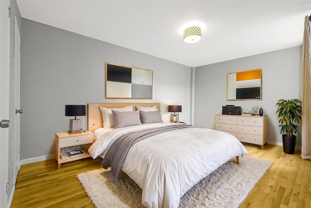 67-30 Clyde St Unit 6W, Forest Hills, NY 11375 - bedroom featuring baseboards and light wood-style floors