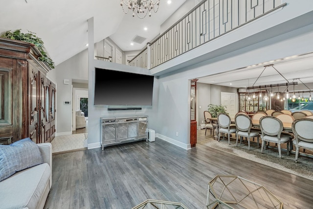 living area with baseboards, wood finished floors, a chandelier, high vaulted ceiling, and recessed lighting